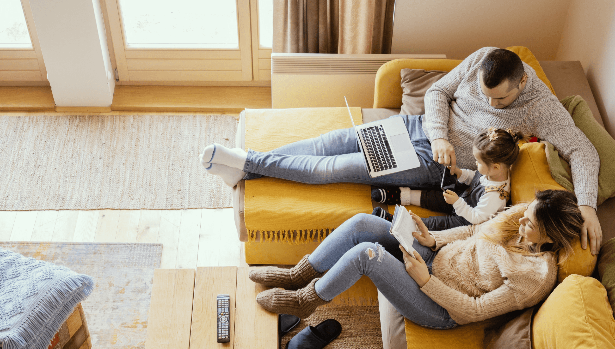 family sitting on a yellow couch